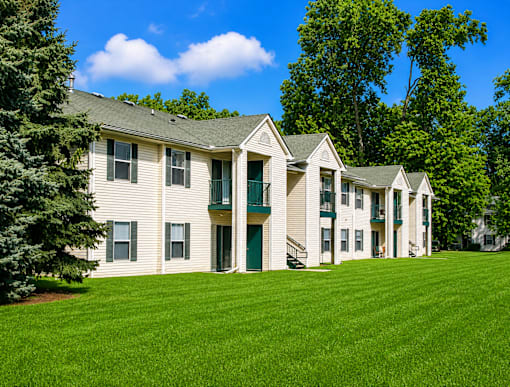 Two story apartment homes with green shutters at Northview Park Apartments, Michigan