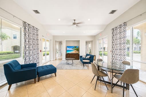 A living room with a blue sofa, a chair, and a table.