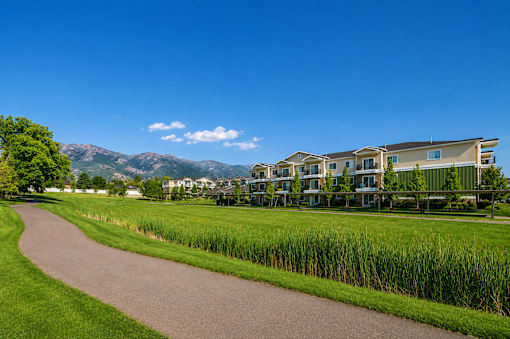 Walking path with mountain views and green space at The Ellison Apartments, Layton, UT 84041