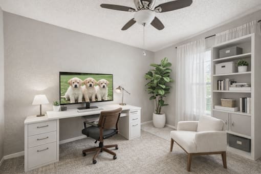 A room with a desk, chair, and a potted plant.