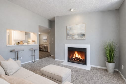 A living room with a fireplace and a painting on the wall.