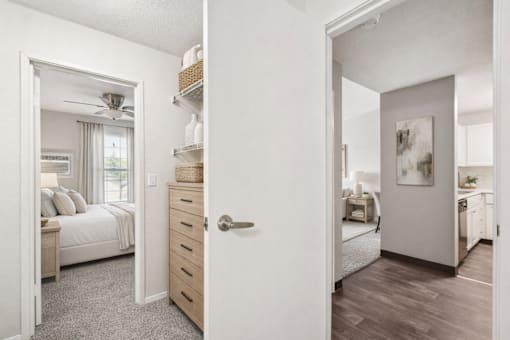 A bedroom with a bed, dresser, and a painting on the wall.