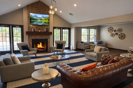 A living room with a fireplace and a television mounted above it.