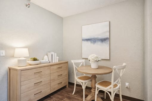 A dining area with a wooden table and chairs.