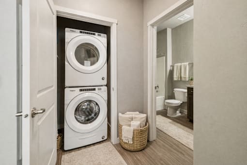 Stacked washer and dryer in closet near bathroom at Harper Ridge Apartments, Meridian, ID