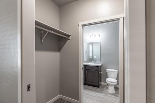 A bathroom with a toilet, sink, and a mirror.
