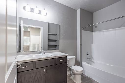 A bathroom with a toilet, sink, and bathtub.
