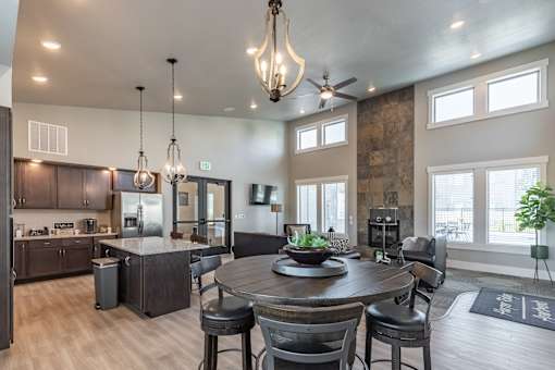 A modern kitchen with a dining table and chairs.