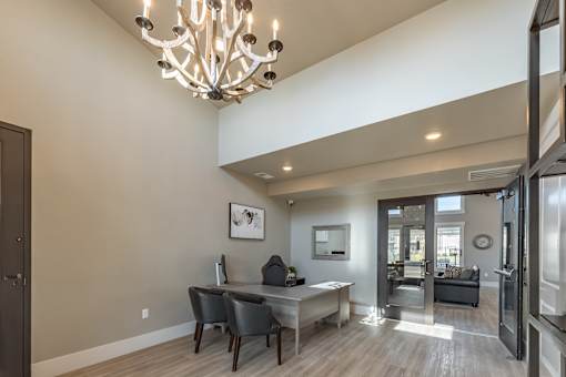A modern dining room with a large table and chairs.