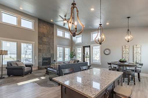 A modern kitchen with a large island and a dining table.