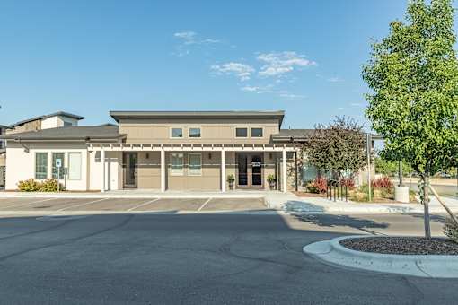 A building with a parking lot in front of it.