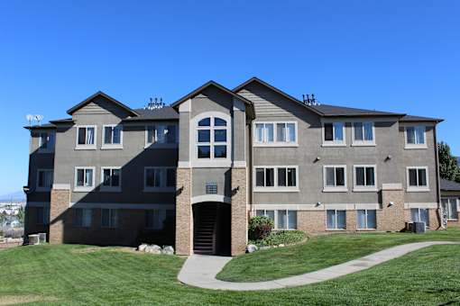 a large apartment building with a sidewalk in front of it