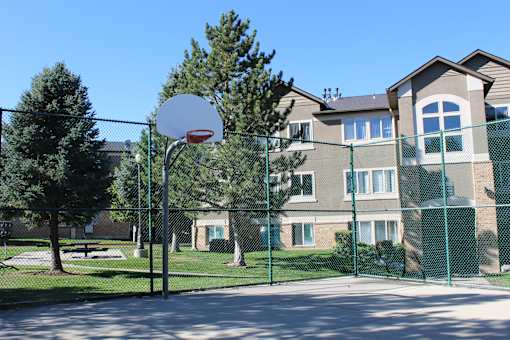 a basketball hoop in front of an apartment building