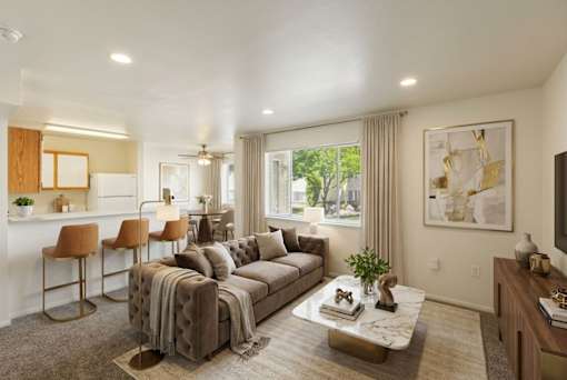 A living room with a couch, chairs, and a coffee table.