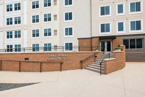 Property entrance sign with brick facade at Lakewood Apartments, Lino Lakes