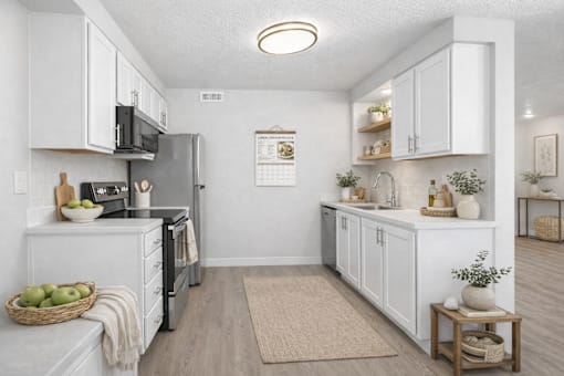 Modern galley kitchen with white cabinets at Fort Lane Apartments, Layton, Utah