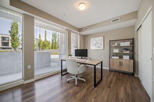 Home office with desk and large windows at Lofts at Innovation Center Apartments, Washington, 99354