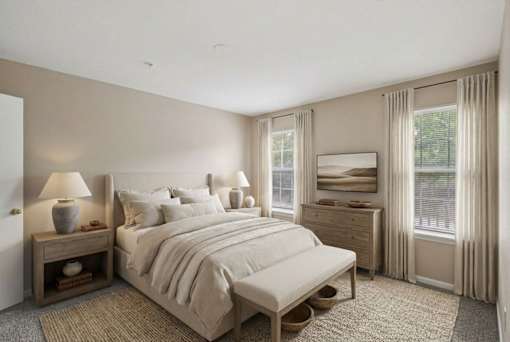 A bedroom with a large bed, nightstand, and window.
