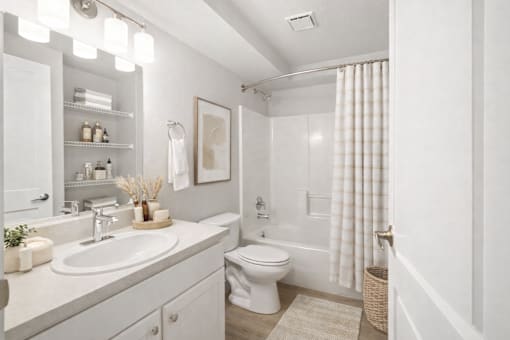 Modern bathroom with white vanity and tub at Fort Lane Apartments, Layton