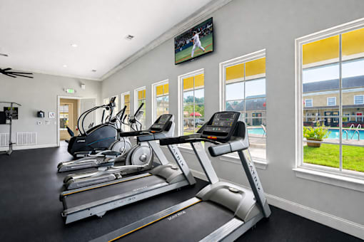 A gym with treadmills and exercise bikes.