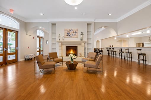 A living room with a fireplace and chairs.