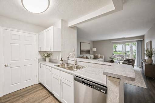 Open concept kitchen with white cabinetry and living area at Northview Park Apartments, Michigan, 48310