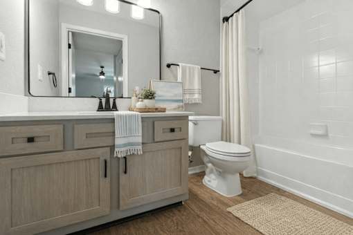 A bathroom with a white toilet, a white bathtub, and a white sink. at Waterbridge Apartments , Florida, 32837