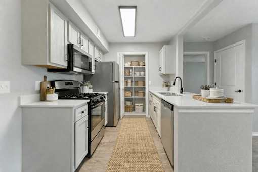 A modern kitchen with a refrigerator, stove, and oven. at Waterbridge Apartments , Orlando
