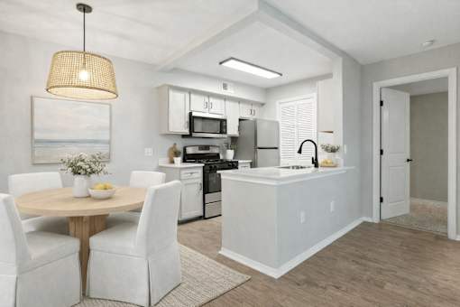 A modern kitchen with a dining table and chairs. at Waterbridge Apartments , Orlando, 32837
