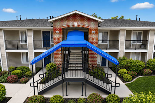 A blue awning is attached to a brick building.