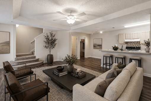 A living room with a couch, chairs, and a coffee table.