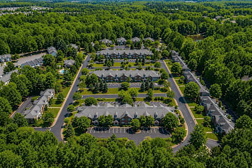 A bird's eye view of a residential area with houses and trees.