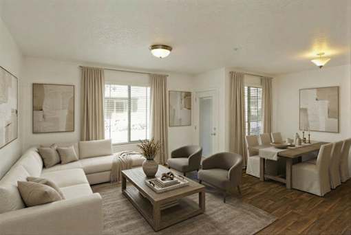 A living room with a white sofa, a grey armchair, and a wooden coffee table.