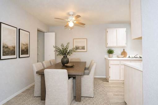 A dining room with a table and chairs.