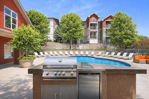 Outdoor grilling station and swimming pool area at Stetson Meadows Apartments, Colorado Springs, CO