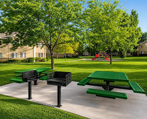 Picnic tables and benches are set up in a park.