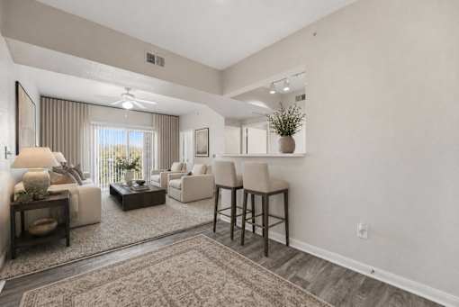 A living room with a couch, chairs, and a rug.