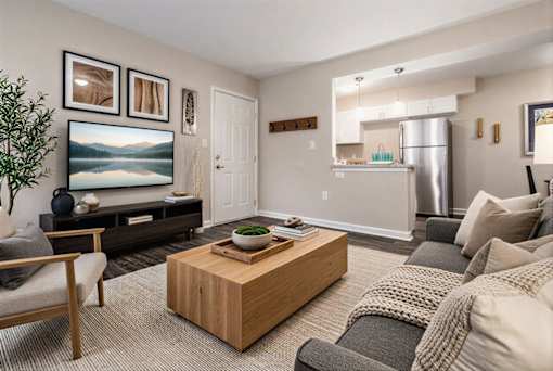 A living room with a wooden coffee table and a grey sofa.