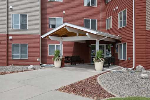 A red building with a covered patio area.