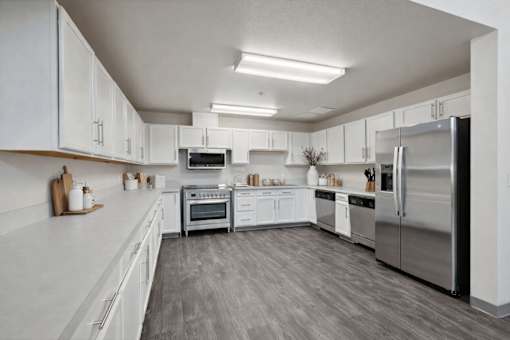 A modern kitchen with stainless steel appliances and white cabinets.