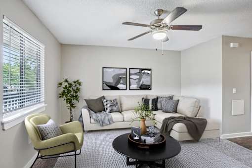 Modern living room with white sectional sofa at Davidson Homes Apartments, Concord, 28027