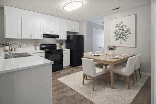 Modern kitchen and dining area with white cabinetry at Davidson Homes Apartments, North Carolina