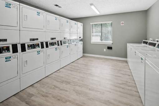 Community laundry facility with stacked washers and dryers at Davidson Homes Apartments, Concord, NC 28027