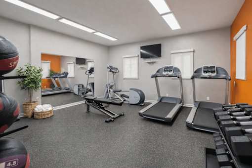 Fitness center with cardio equipment and weights at Vista Linda Apartments, Santa Fe, NM
