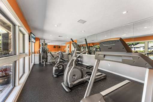 A gym with treadmills, exercise bikes, and other equipment. at Epic Apartments , Apartments, Daytona Beach, FL