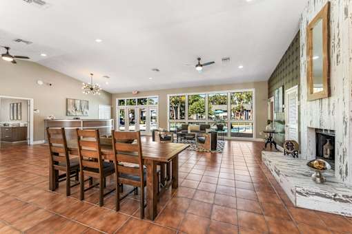 A large dining room with a wooden table and chairs. at Epic Apartments , Daytona Beach, 32114