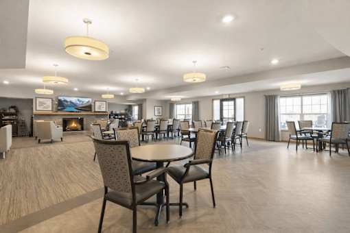 Spacious dining room with fireplace and seating at The Estates at Arbor Oaks Apartments, Andover, 55304