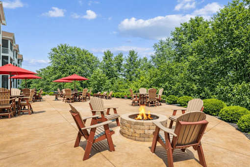 Outdoor fire pit patio with seating areas at The Estates at Arbor Oaks Apartments, Andover
