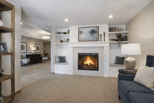 Living room with built in fireplace and shelving at The Estates at Arbor Oaks Apartments, Andover, Minnesota