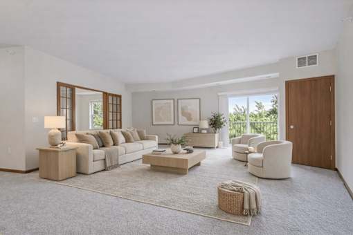 Living room with sliding doors and balcony access at The Estates at Arbor Oaks Apartments, Andover
